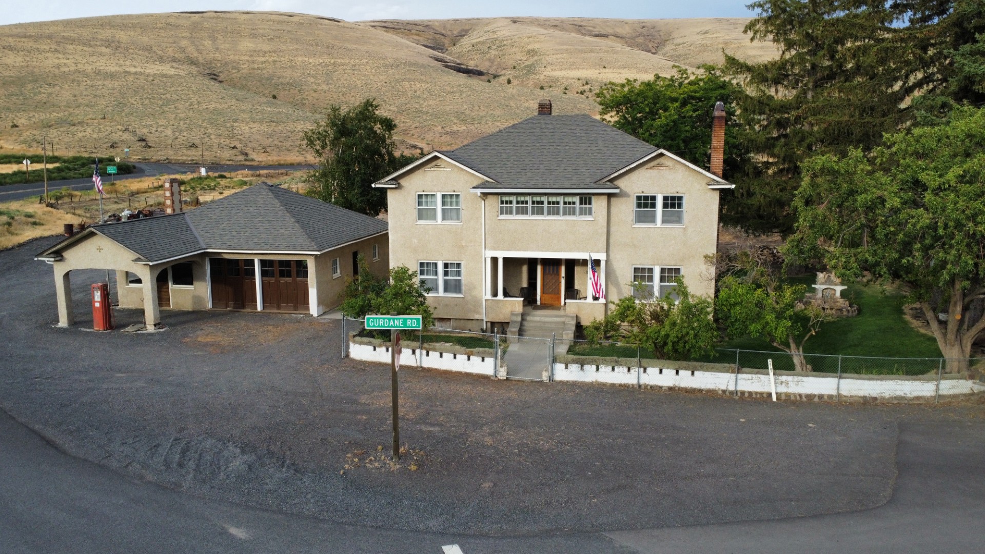 exterior, aerial view of the front of the historic home and 1920s service station